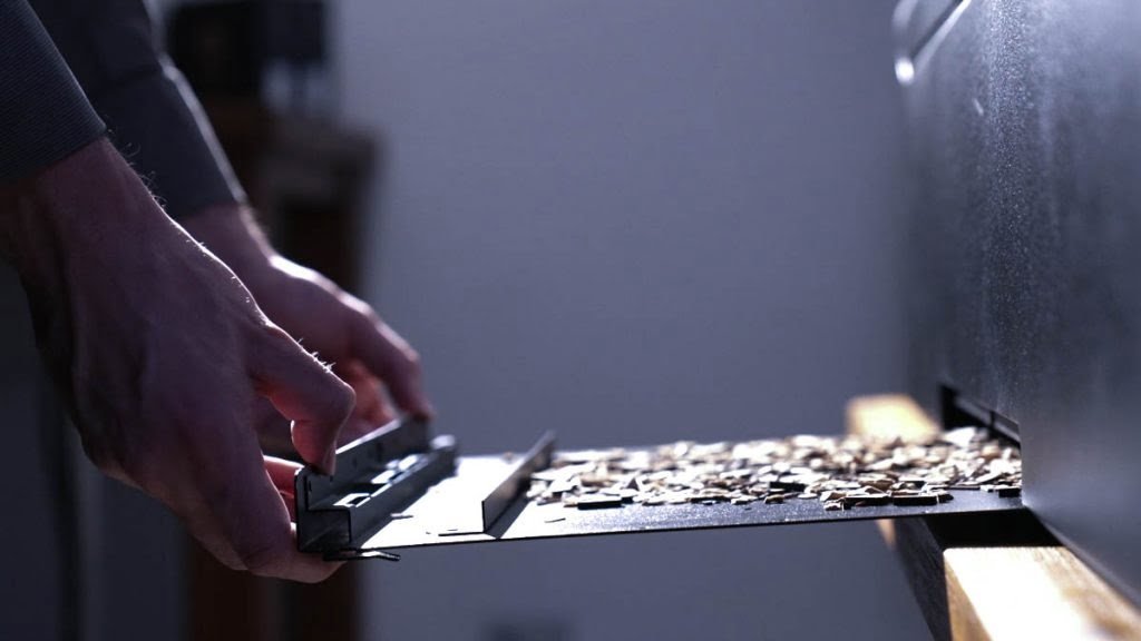 Hands Pulling Out The Laser Cutter Waste Tray