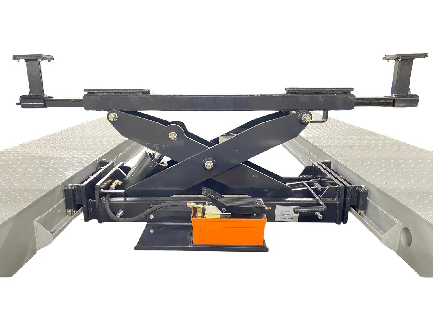 Rolling bridge jack scissor mechanism mounted between four-post lift runways, foot-pedal power unit at base